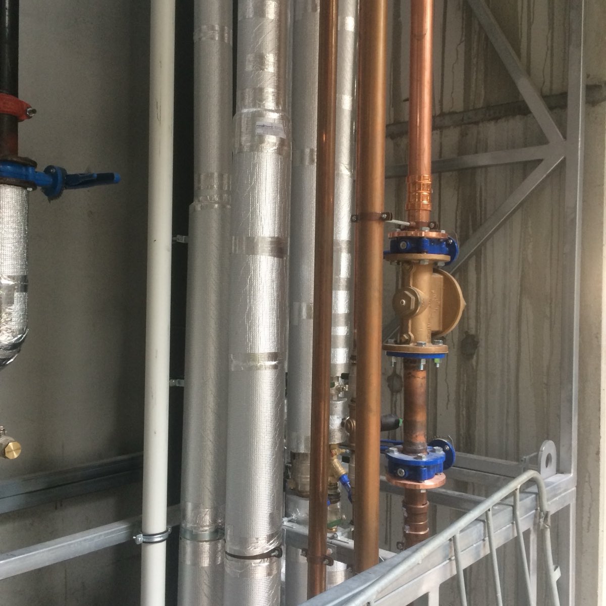 The same style of copper pipework and brass valve, evenly lit, with the fittings and workmanship clearly visible
