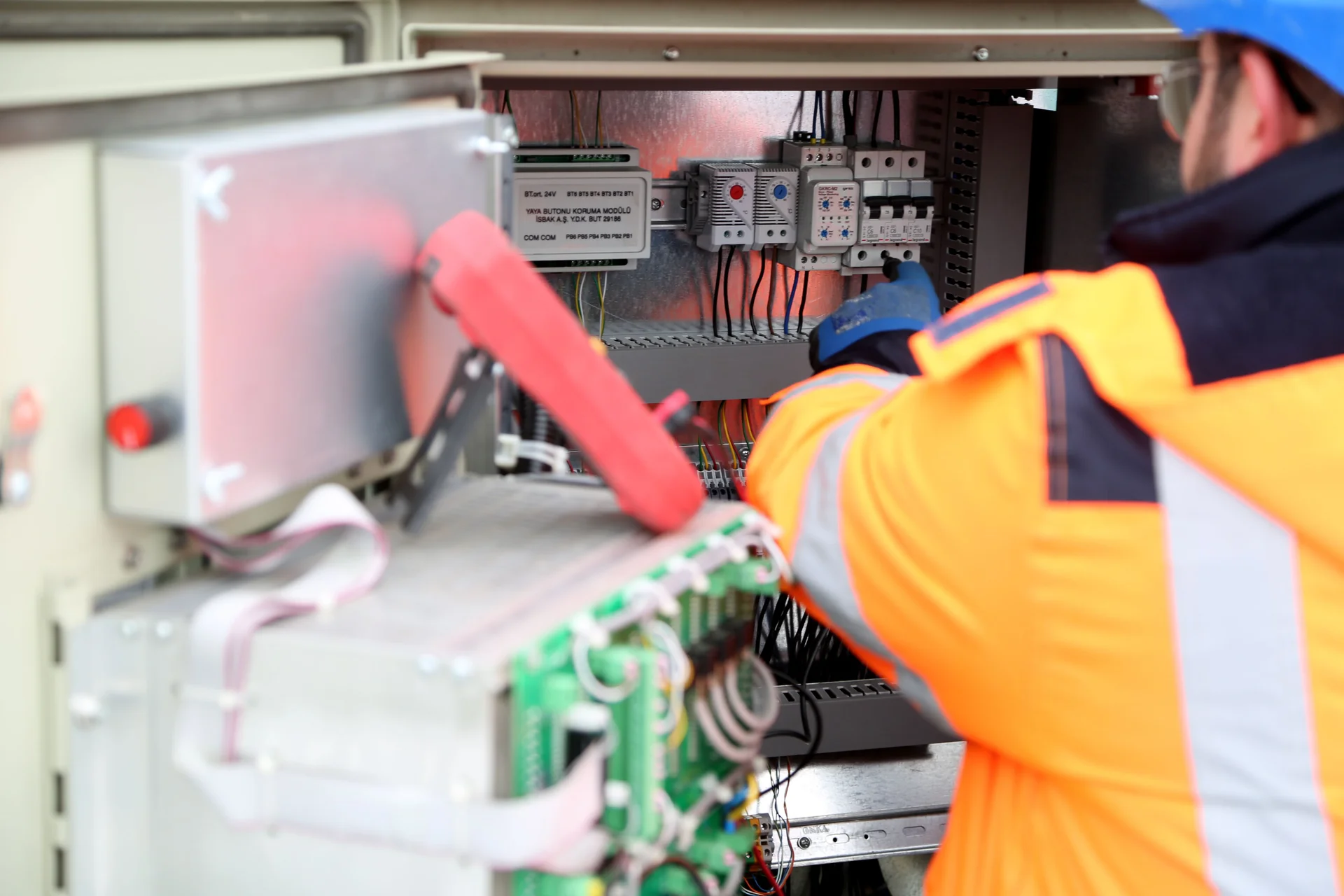 Illustrative photograph of an electrician maintaining an inverter