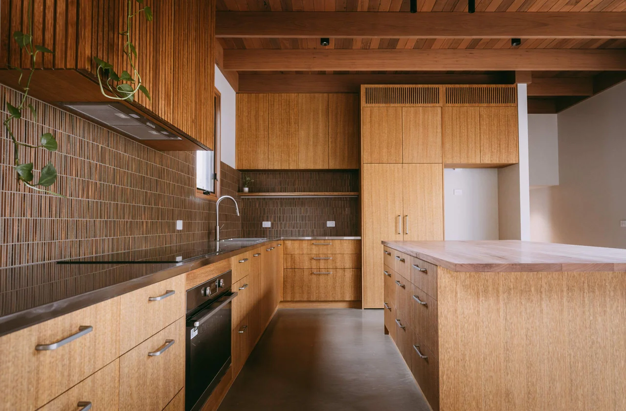 Kitchen with timber cabinetry and a tiled splashback