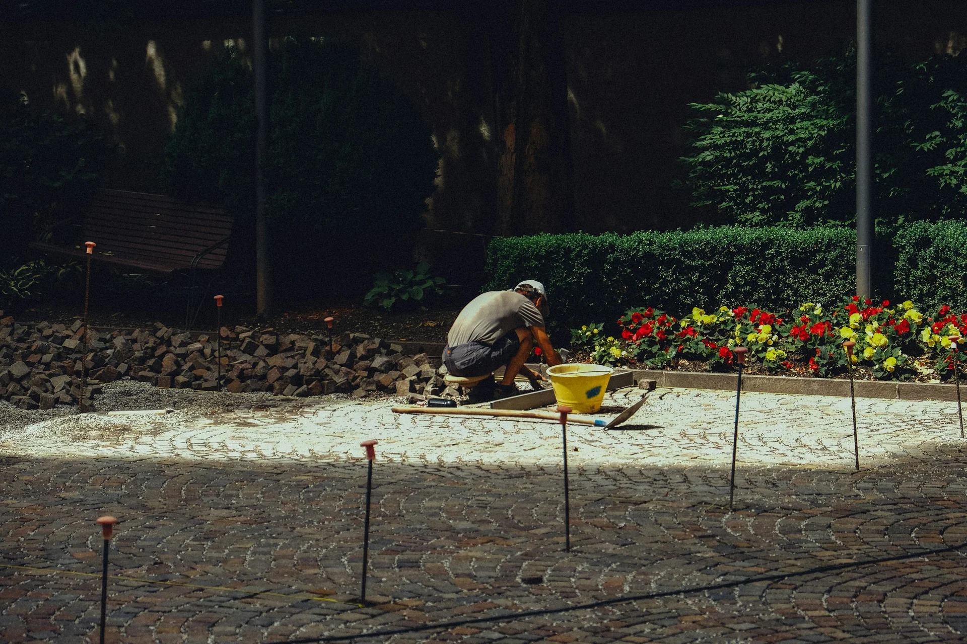 Illustrative photograph of a landscaper laying garden paving